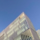 Upper corner of an office building and evening sky background. Like in a photo visibility increases understanding of a subject.